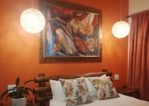 a bedroom with a painting and a bed with pillows at AshTree GuestHouse in Hanover