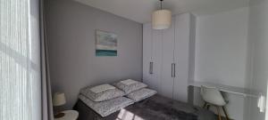a small room with two beds and a table at Apartament nad Sapiną 2 in Kruklanki