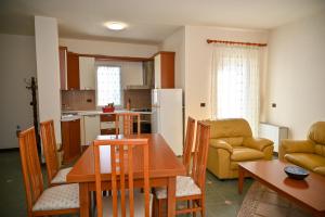 a kitchen and living room with a table and chairs at Hotel Vila Emes in Durrës