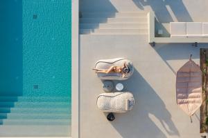 dwa bagaże leżące obok basenu w obiekcie Manto Villas, Heated Pool, Spa Whirlpool, SeaView, By ThinkVilla w mieście Prinés