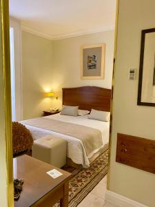 a hotel room with a bed and a table at Hotel Akropolis - Museum Hotel in Taranto