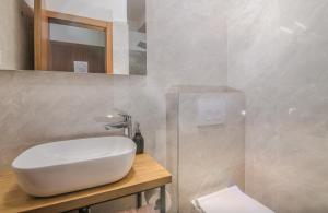 a bathroom with a white sink and a toilet at B&B Šegulja in Malinska +86 photos