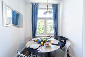 Un comedor con una mesa y una ventana. en TOTU HOME Wajdeloty 5 Rooms Gdańsk, en Gdansk