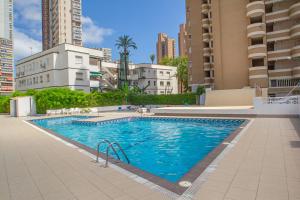 a swimming pool in a city with tall buildings at Serisol Holidays in Benidorm