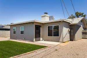 a small grey house with a grass yard at Cozy 3BR House Near Attractions & Shopping in Phoenix
