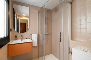 a bathroom with a sink and a shower at Hotel Robson - Smart Hotel in Lloret de Mar