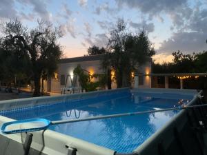a large swimming pool in front of a house at Muschiaturo in Foce Varano