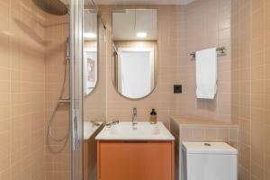 a bathroom with a sink and a toilet and a mirror at Hotel Robson - Smart Hotel in Lloret de Mar