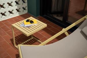 a small table with a book on it next to a chair at Hotel Robson - Smart Hotel in Lloret de Mar