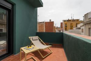 a chair sitting on top of a balcony at Hotel Robson - Smart Hotel in Lloret de Mar