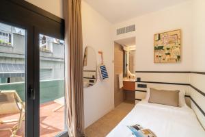 a small room with a bed and a window at Hotel Robson - Smart Hotel in Lloret de Mar