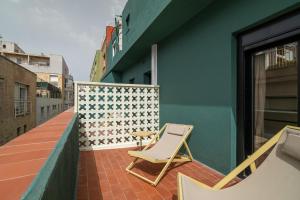 a chair sitting on the balcony of a building at Hotel Robson - Smart Hotel in Lloret de Mar