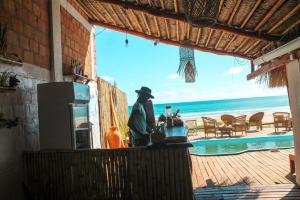 a statue of a person sitting on a table near the beach at Lehani Beach Hostel in Praia do Tofo