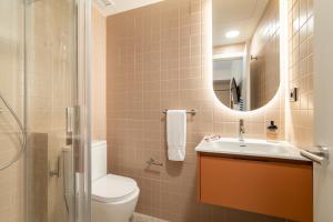 a bathroom with a toilet and a sink and a mirror at Hotel Robson - Smart Hotel in Lloret de Mar