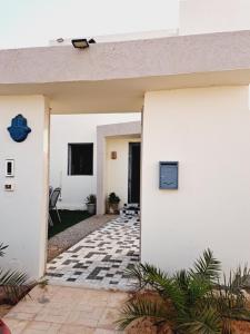 a white house with a tv on the wall at Villa HANA in Midoun