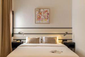 a bedroom with a bed with two lamps on it at Hotel Robson - Smart Hotel in Lloret de Mar