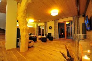 a living room with a tree in the middle of it at 5 Sterne Ferienhaus Bayern in Untergriesbach