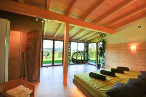 a bedroom with a bed in a room with windows at 5 Sterne Ferienhaus Bayern in Untergriesbach