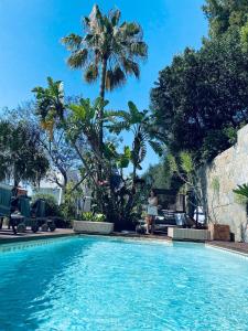 a woman standing next to a swimming pool at Marbella Boutique Art suites in Marbella