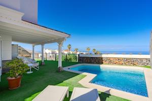 a backyard with a swimming pool and a patio at Villa Casablanca by Welcome Tenerife in Chayofa