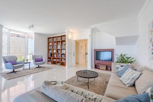 a living room with a couch and a tv at Villa Casablanca by Welcome Tenerife in Chayofa