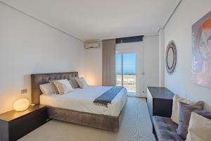a bedroom with a large bed and a couch at Villa Casablanca by Welcome Tenerife in Chayofa +18 photos