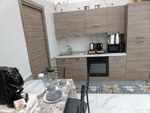 a kitchen with a table with dishes on it at Maison Chic in Ercolano