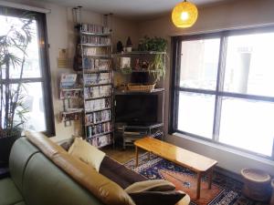 a living room with a couch and a coffee table at Backpackers Hostel Ino's Place in Sapporo