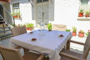 a table with glasses and plates on it on a patio at Stergjo Townview Residences in Berat