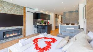 a living room with a white couch and a fireplace at Le Reflet du Lac in Tresserves