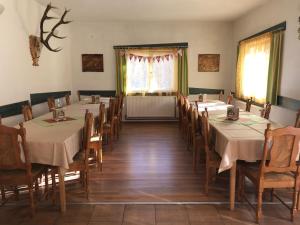 a dining room with tables and chairs in it at Mont Crai in Zărneşti