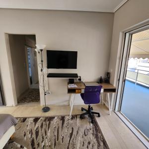 a bedroom with a desk and a tv on a wall at Elite Port in Piraeus +4 photos