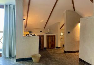 a kitchen with a counter top in a room at Baobab Bungalows in Jambiani +198 photos