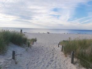 a sandy beach with the ocean in the background at Domek na Błotach in Karwieńskie Błoto Drugie