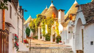 an alley in a town with white buildings at Stanza matrimoniale bagno privato in Mola di Bari