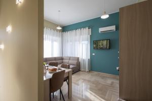 a living room with a table and a couch at Casa del Sole - Holiday Home in Diso