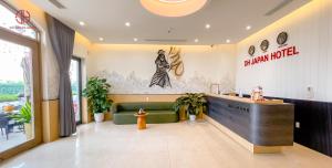 a lobby of a restaurant with a green couch and a counter at DH Japan Hotel in Ha Long