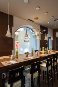 a large dining room with a long table and chairs at Abba Rambla Hotel in Barcelona