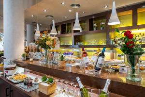 a bar with wine bottles and glasses on a counter at Abba Rambla Hotel in Barcelona