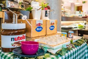 a table with some food and drinks on it at Abba Rambla Hotel in Barcelona