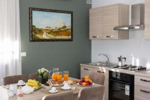 a kitchen with a table with fruit on it at Casa del Sole - Holiday Home in Diso
