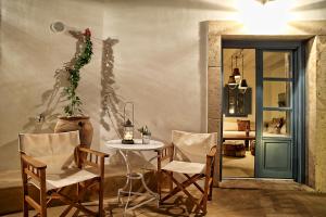 a room with a table and chairs and a door at Blue Bay Patmos Summer House in Grikos +28 photos
