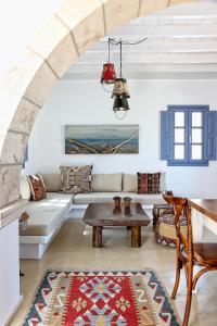 a living room with a couch and a table at Blue Bay Patmos Summer House in Grikos