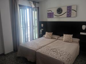 Posteľ alebo postele v izbe v ubytovaní Hotel de Los Faroles