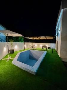 a backyard with a swimming pool at night at Počitelj Holiday House in Počitelj