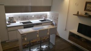 a small kitchen with a sink and a counter at Sweet Dreams Apartment in Arandelovac