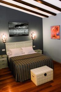 a bedroom with a large bed and two night stands at Hotel Rural La Cabaña in Palazuelos