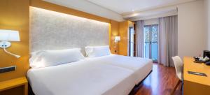 a large white bed in a hotel room at Abba Rambla Hotel in Barcelona