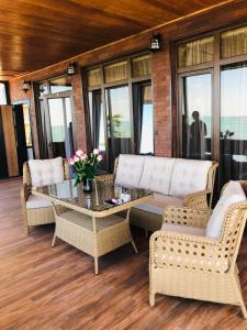 a living room with a couch and chairs and a table at Mzıurı House 1 in Batumi