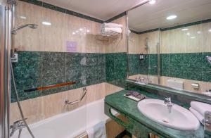 a bathroom with a sink and a shower at Abba Rambla Hotel in Barcelona